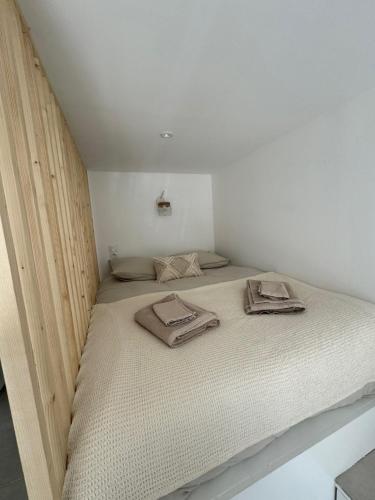 a bed in a room with two towels on it at Chez Timmaflo in Fréjus