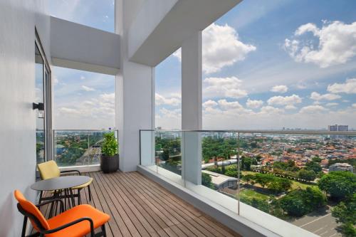 a balcony with a view of a city at Aloft South Jakarta in Jakarta