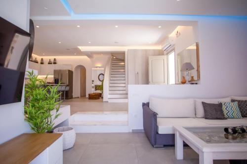 a living room with a couch and a table at VILLA PANAMERA Mykonos, Private Heaven, Supreme View! in Fanari