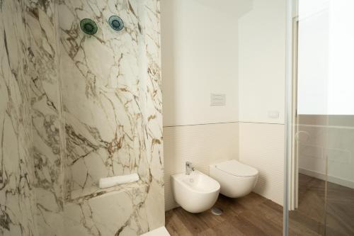 a bathroom with a toilet and a glass shower at Blumarea in Agropoli