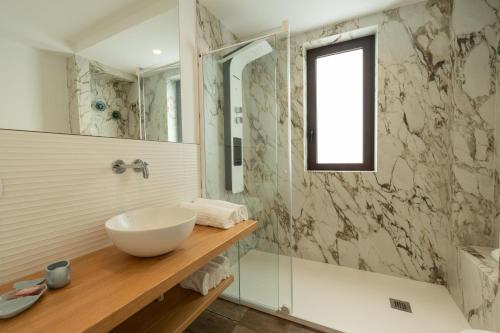 a bathroom with a sink and a glass shower at Blumarea in Agropoli
