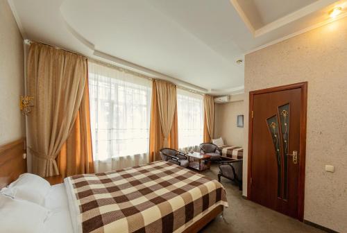 a hotel room with a bed and a window at Ajour in Almaty