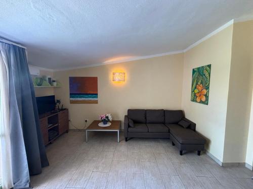 a living room with a couch and a table at Cozy Apartment with Pool, near Beach and Center in Santa Maria