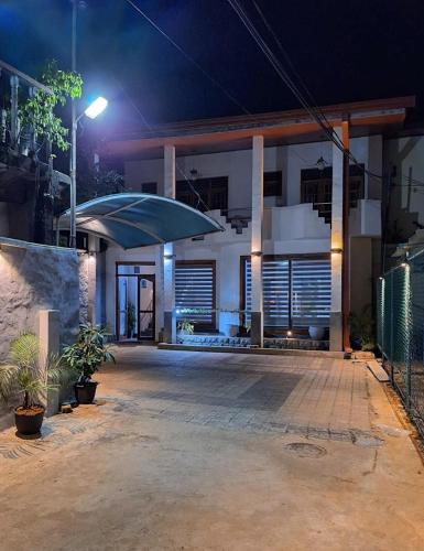 a house with an umbrella in front of it at night at Mount View Inn in Kandy