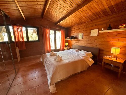 a bedroom with a bed in a wooden cabin at Casa Clot III- Formentera in Illes Balears