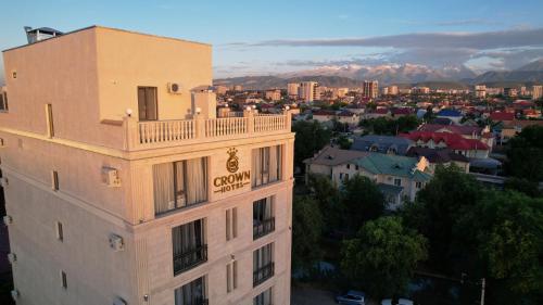 a building with a sign on the top of it at Crown Hotel in Bishkek