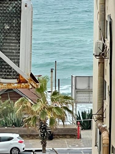 a view of the ocean from a building at Bat Yam Penthouse Sea View in Bat Yam