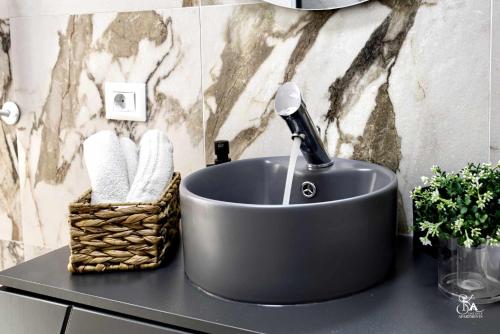 a sink with a blow dryer in a bathroom at Sika Splendor Apartment - cazare premium Arad - self check-in in Arad