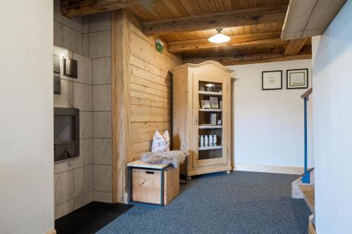 a room with a tv and a chair in a room at Gasthof Kreuz in Bildstein