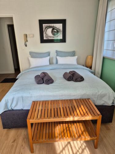 a bedroom with a large bed with a wooden bench at Bulle D'eau in Spa