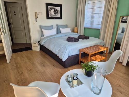 a bedroom with a bed and a table and chairs at Bulle D'eau in Spa
