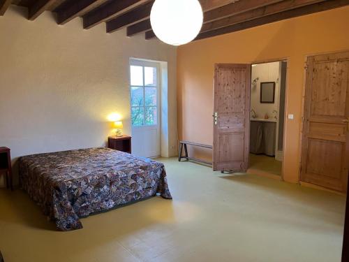 a bedroom with a bed and a window and a lamp at La Brionniere in Aizenay