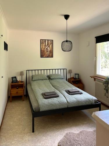 a bedroom with a bed with two pillows on it at Sixty Six Degrees North - Lapland Home & Forest in Överkalix