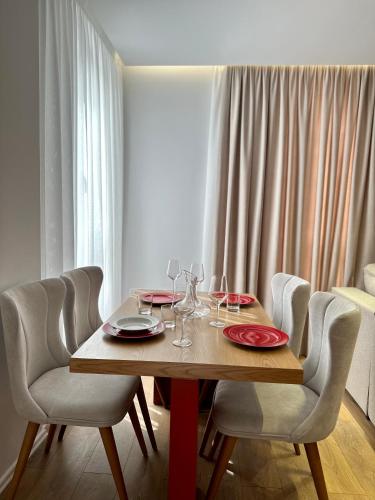a dining room table with glasses and plates on it at SUV ApartHotel in Pogradec