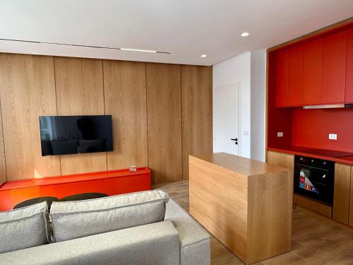 a living room with a couch and a flat screen tv at SUV ApartHotel in Pogradec