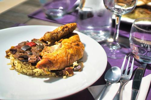 a plate of food with meat and rice on a table at Kyriad Prestige Mulhouse - Basel in Sausheim