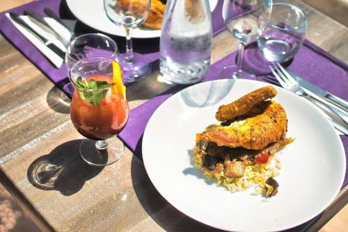 a table with a plate of food on a table at Kyriad Prestige Mulhouse - Basel in Sausheim