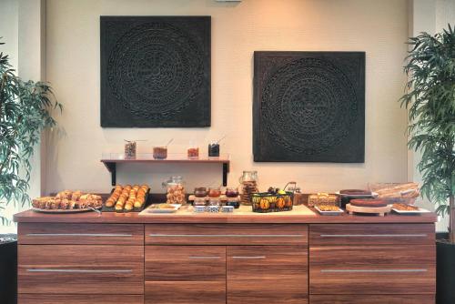 a buffet with bread and other foods on a table at Kyriad Prestige Mulhouse - Basel in Sausheim