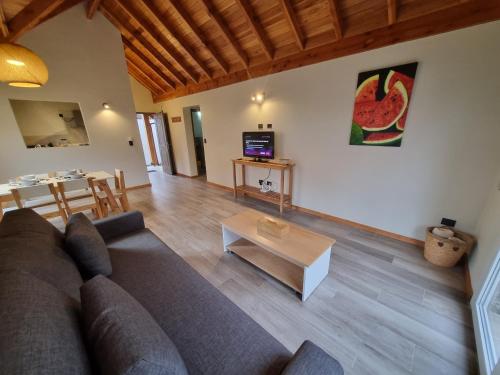 a living room with a couch and a table at Del Lacar - Andarlibre in San Martín de los Andes