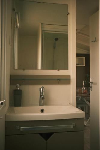a bathroom with a sink and a mirror at Campingplatz Johannisberg in Fehmarn