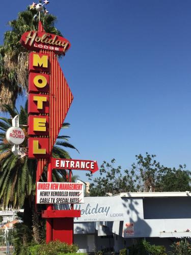 a large sign for a mr and mrs entrance at Holiday Lodge in Los Angeles