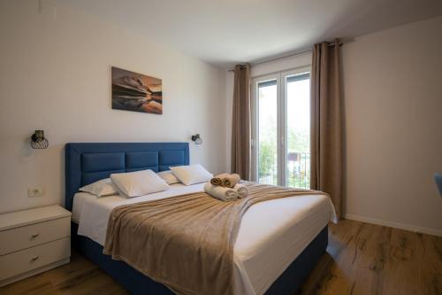 a bedroom with a teddy bear sitting on a bed at Apartment Iva in Vrana
