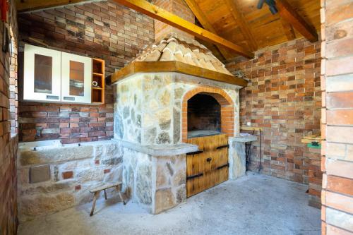 a large stone oven in a brick wall at Apartment Iva in Vrana