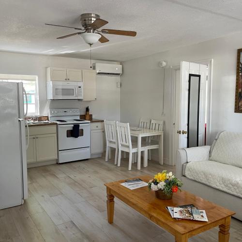 a kitchen and living room with a couch and a table at Kings Kamp in Key Largo