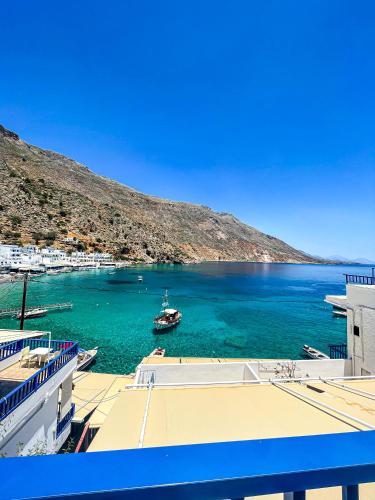 a boat in a large body of water at The Blue House in Loutro