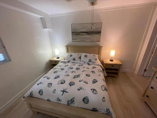 a bedroom with a bed and two night stands at Kings Kamp in Key Largo