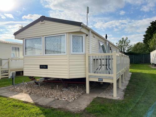 a tiny house sitting on top of a yard at Goodwin's static caravan in Mablethorpe