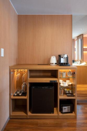 a kitchen with a counter with a microwave at Hotel Tokinoza in Kihokucho