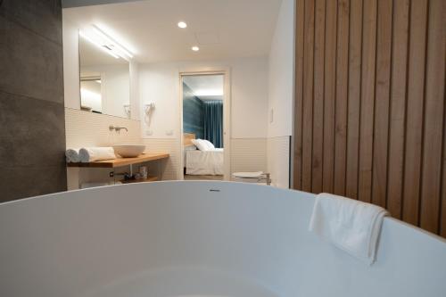 a bathroom with a white tub and a sink at Blumarea in Agropoli
