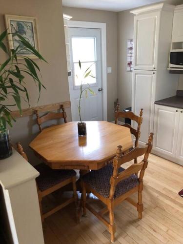 a wooden table and chairs in a kitchen with a table at Chalet des rennes in Bertrand