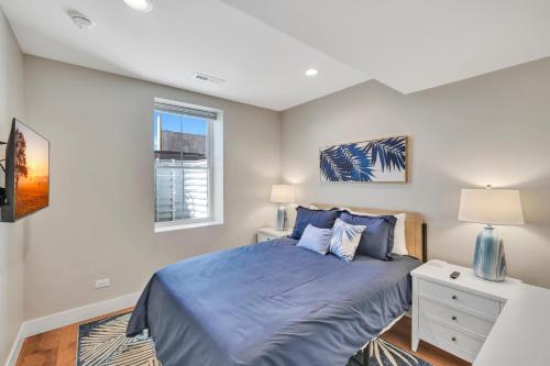a bedroom with a blue bed and a window at A View to a Chill in Ottawa