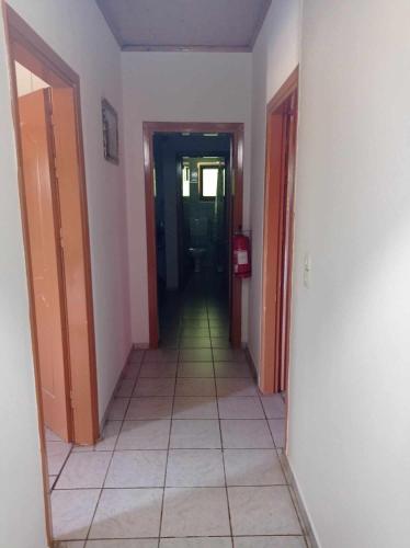 a hallway with several doors and a tile floor at Το Πέρασμα in Vitsiríni