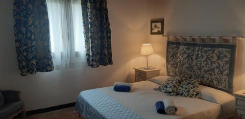 a bedroom with a bed and a window at Casa Logos Stintino - Private pool in Stintino