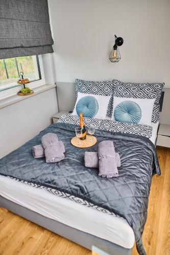 a bedroom with a bed with a table on it at Babichy 29 DOM Apartamenty MANDORIA , Rodzina , Family , Orientarium , PTAK , Parking bezpłatny in Babichy