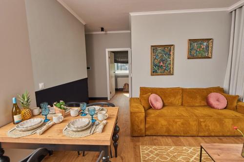 a living room with a couch and a table at Babichy 29 DOM Apartamenty MANDORIA , Rodzina , Family , Orientarium , PTAK , Parking bezpłatny in Babichy