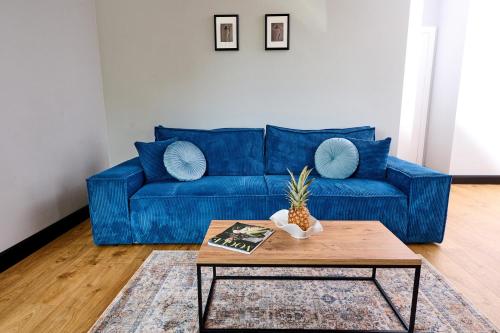 a blue couch in a living room with a coffee table at Babichy 29 DOM Apartamenty MANDORIA , Rodzina , Family , Orientarium , PTAK , Parking bezpłatny in Babichy