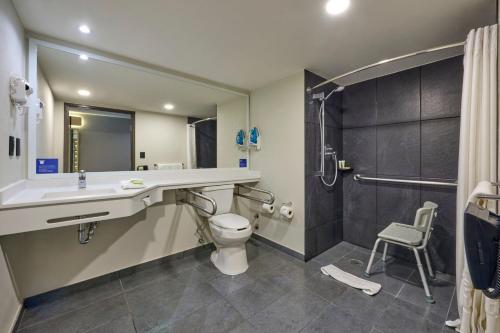 a bathroom with a sink and a toilet and a shower at City Express by Marriott Ciudad de México La Villa in Mexico City