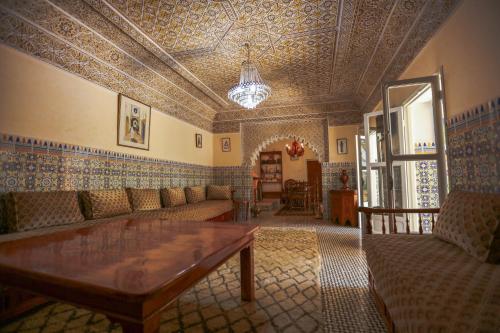 a living room with a couch and a table at Riad Isla in Essaouira