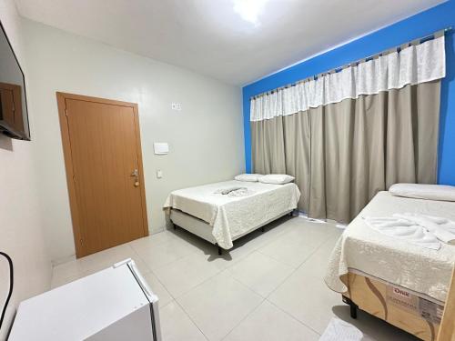 a hospital room with two beds and a window at Perola dos lençóis in Barreirinhas
