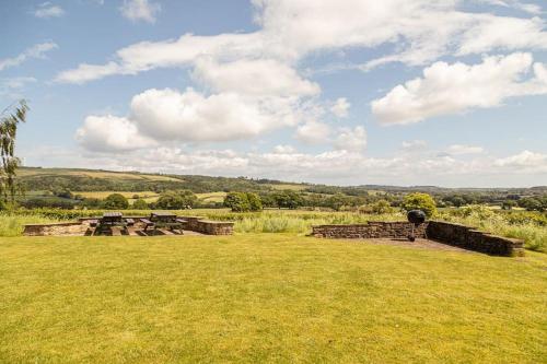 a field with stone buildings in the middle of a field at Swallows’ Barn in Durham