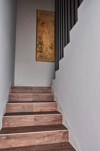 a set of stairs with a painting on the wall at Babichy 29 DOM Apartamenty MANDORIA , Rodzina , Family , Orientarium , PTAK , Parking bezpłatny in Babichy