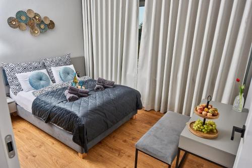 a bedroom with a bed and a table with a bowl of fruit at Babichy 29 DOM Apartamenty MANDORIA , Rodzina , Family , Orientarium , PTAK , Parking bezpłatny in Babichy