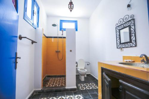 a bathroom with a toilet and a sink at Riad Isla in Essaouira