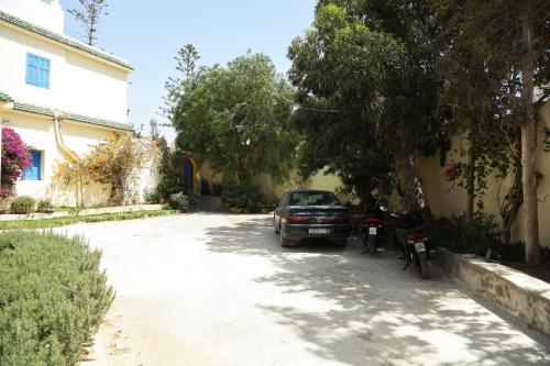 a car parked on the side of a driveway at Riad Isla in Essaouira