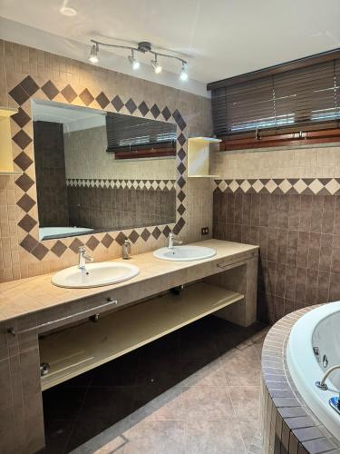 a bathroom with two sinks and a large mirror at DolceVita Eur2 Luxury Apartament in Rome