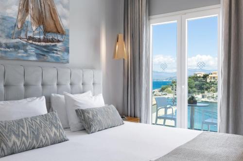 a bedroom with a bed with a view of the ocean at Melina Bay Boutique Hotel in Kassiopi